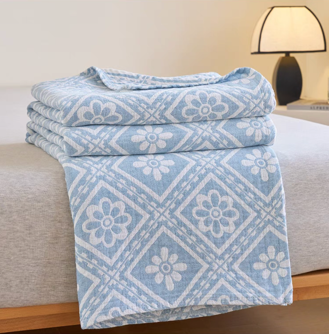 Nature Cotton Quilt Blue Chrysanthemum draped on bed showing cotton gauze jacquard floral pattern