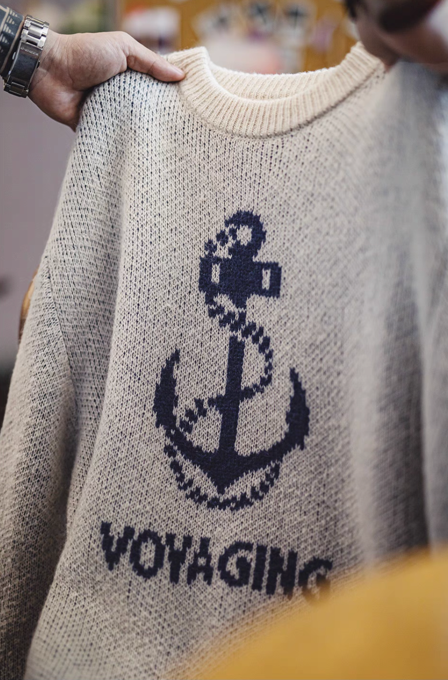 Close-up of Nautical Anchor Knit Sweater Gray Blue held in hand highlighting anchor pattern and breathable knit texture