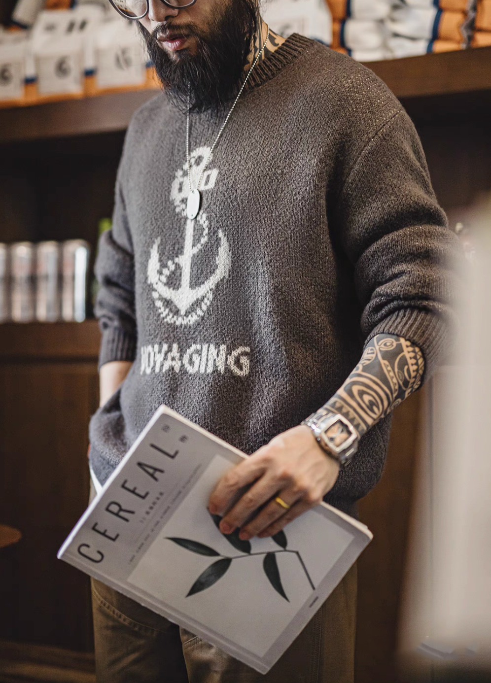 Close-up of Nautical Anchor Knit Sweater Gray Brown worn on body showing textured knit sleeves and anchor detail