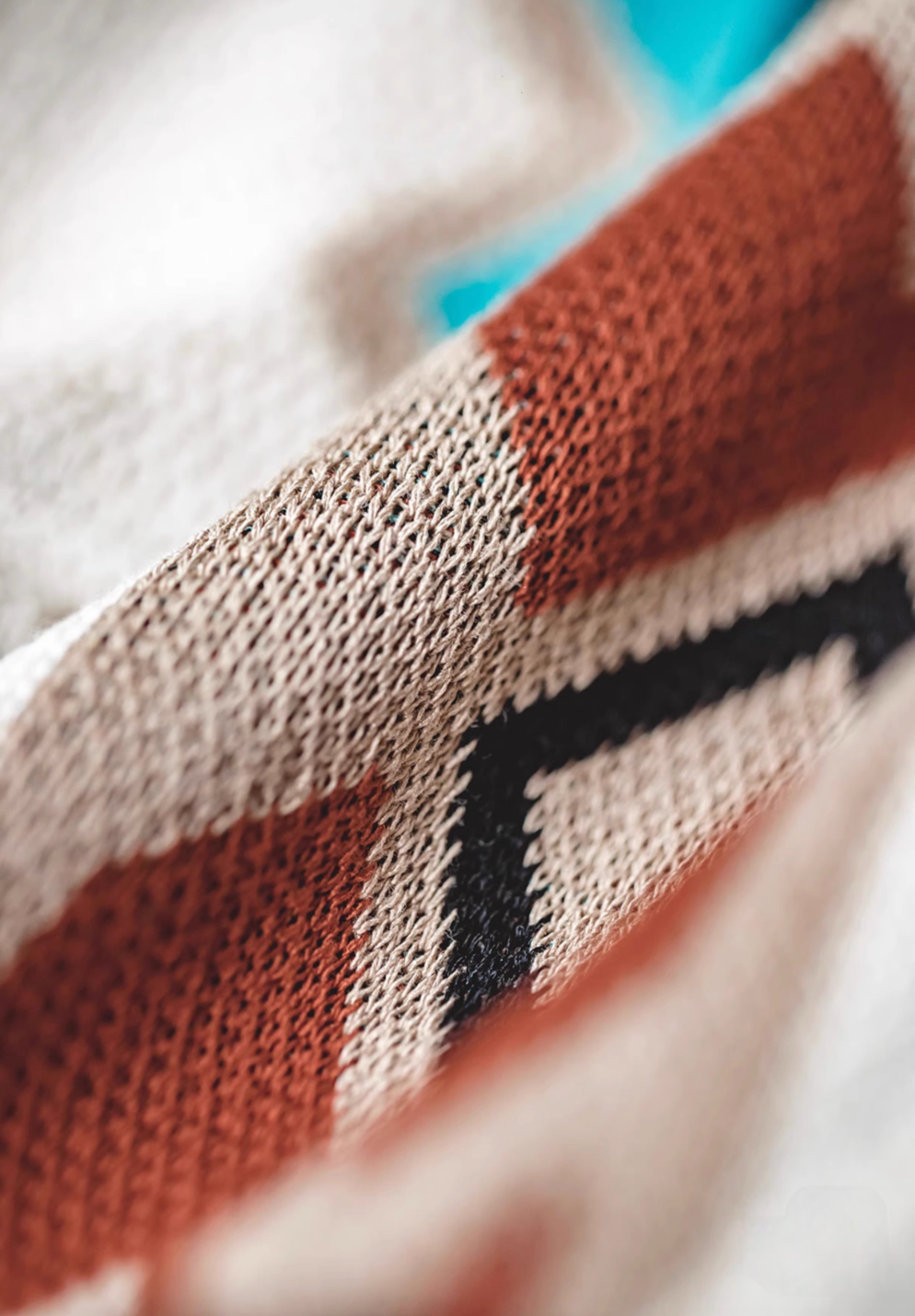 Navajo-Inspired Geometric Knit Beach Shorts diamond pattern macro close-up showing yarn texture and geometric knit pattern
