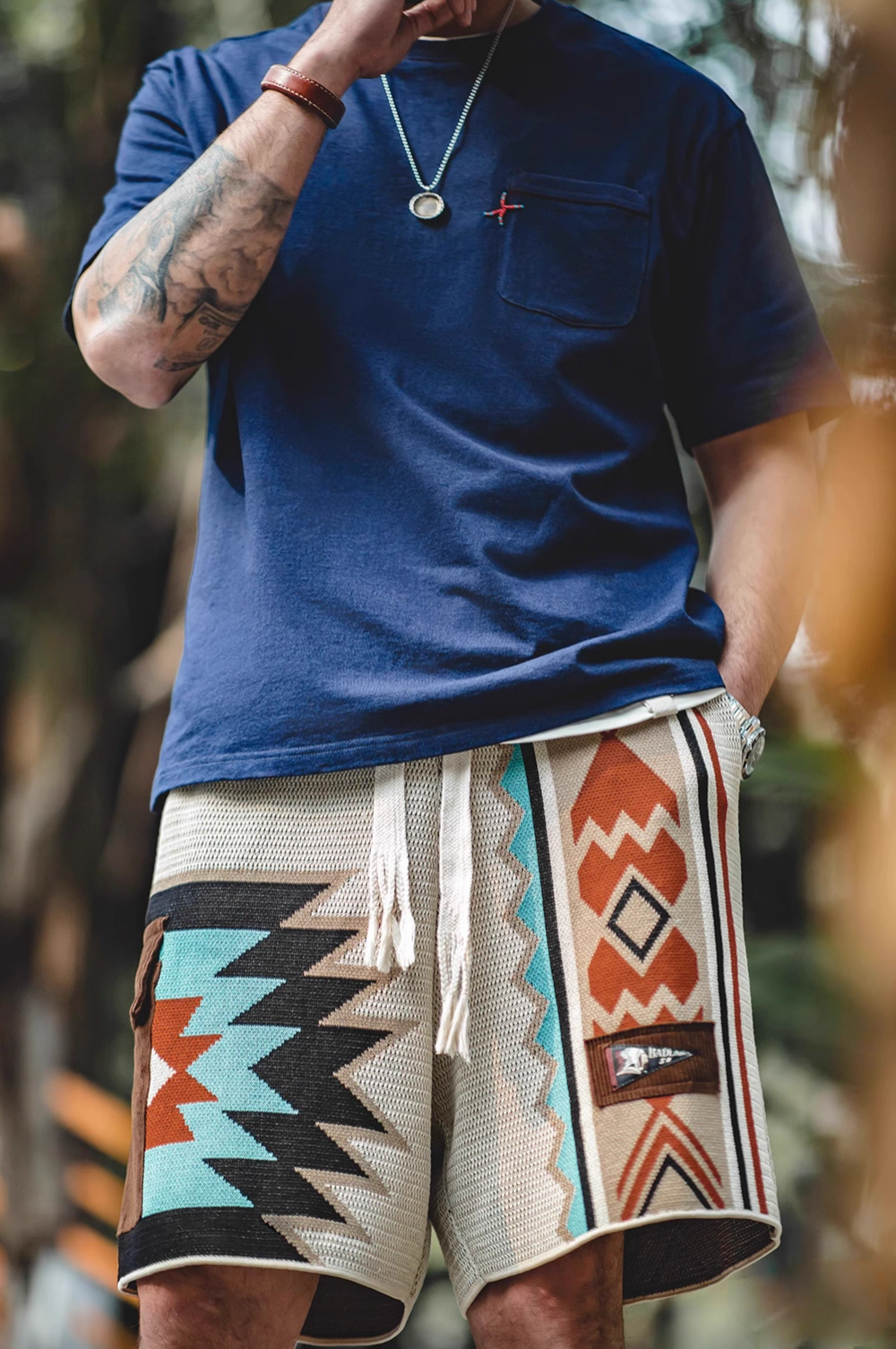 Navajo-Inspired Geometric Knit Beach Shorts diamond pattern full body lifestyle view showing elastic waist and vertical patchwork design