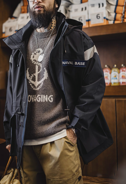 Model wearing parka with anchor sweater underneath, emphasizing nautical military style