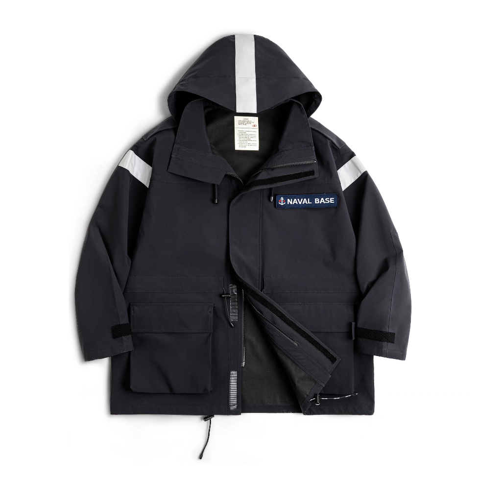 Front flat lay of deep navy “Naval Base” reflective hooded parka with patch and large utility pockets