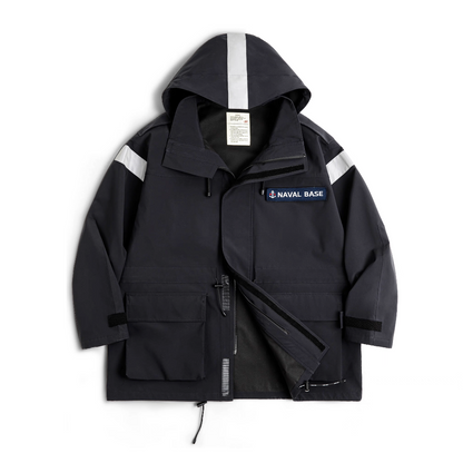 Front flat lay of deep navy “Naval Base” reflective hooded parka with patch and large utility pockets