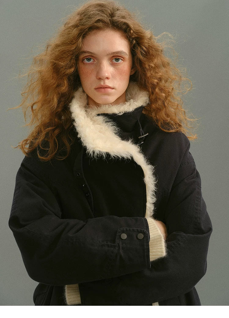 Navy cotton parka with the shearling collar turned up and snap cuffs