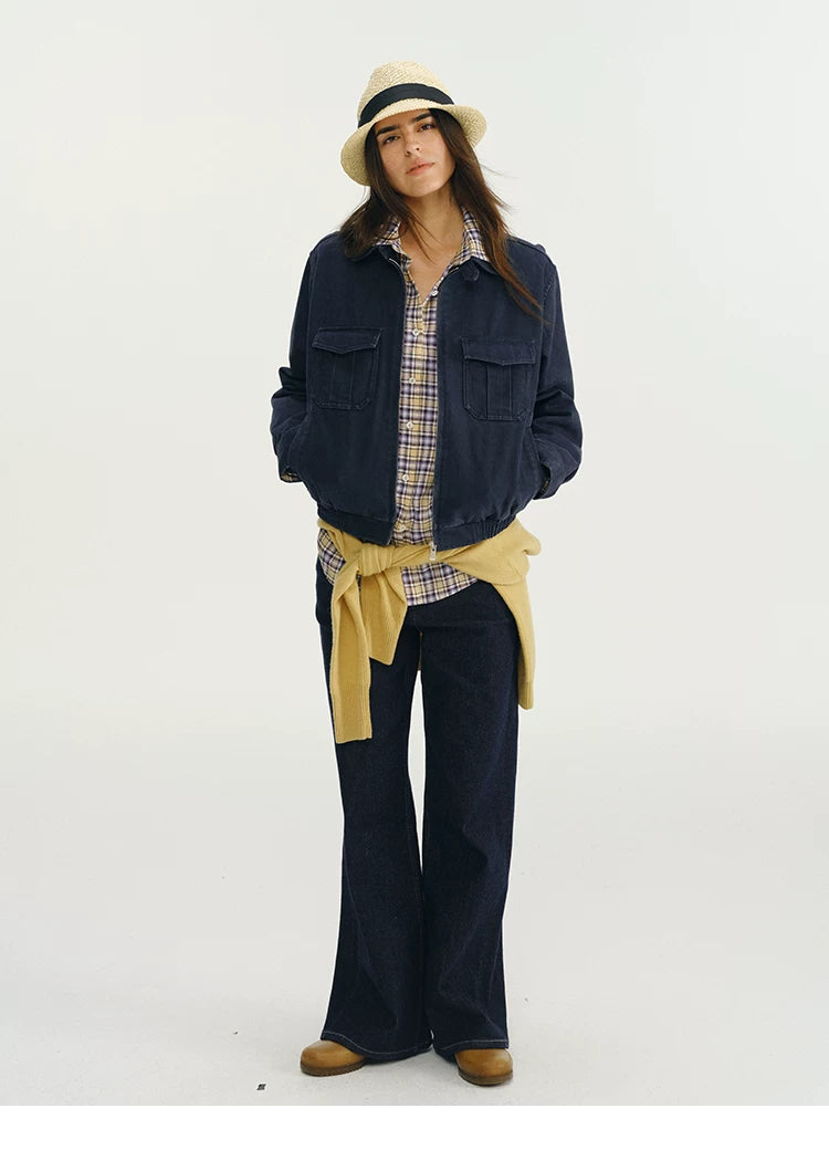 Full-length front view of a navy cropped utility jacket with two flap chest pockets