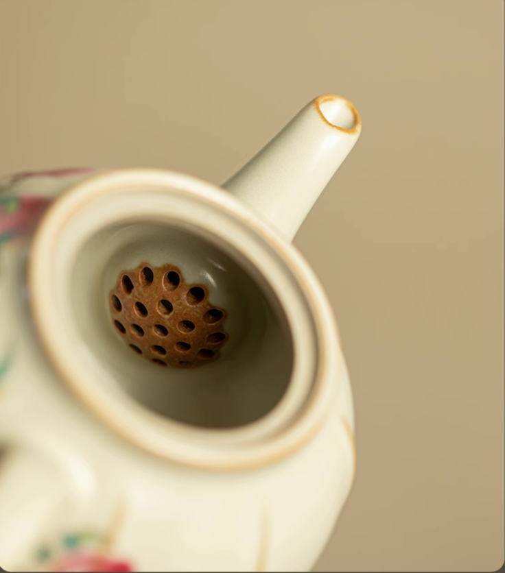 Close-up of Nine Peach Ru Kiln Crackle Glazed Teapot in Nine Peach showing built-in spout filter and inner ceramic detail