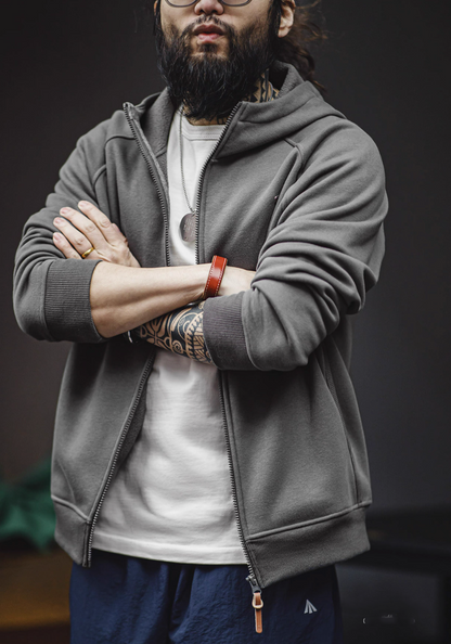 Deep floral grey zip hoodie front styling with folded arms showing structured fit and casual streetwear outfit