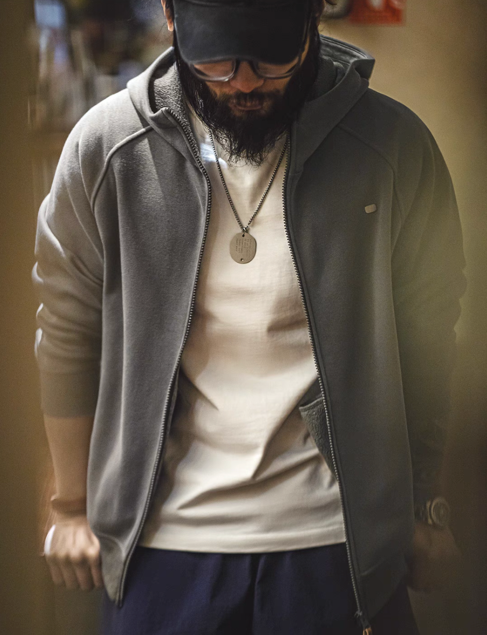 Deep floral grey Nordic Comfort zip hoodie front view worn with zip-up closure and layered t-shirt styling