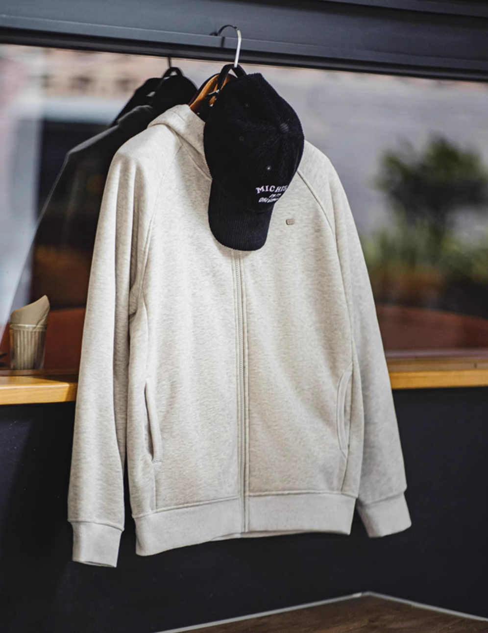 Snowflake white Nordic Comfort zip hoodie front view hanging display with full zip closure and front pockets
