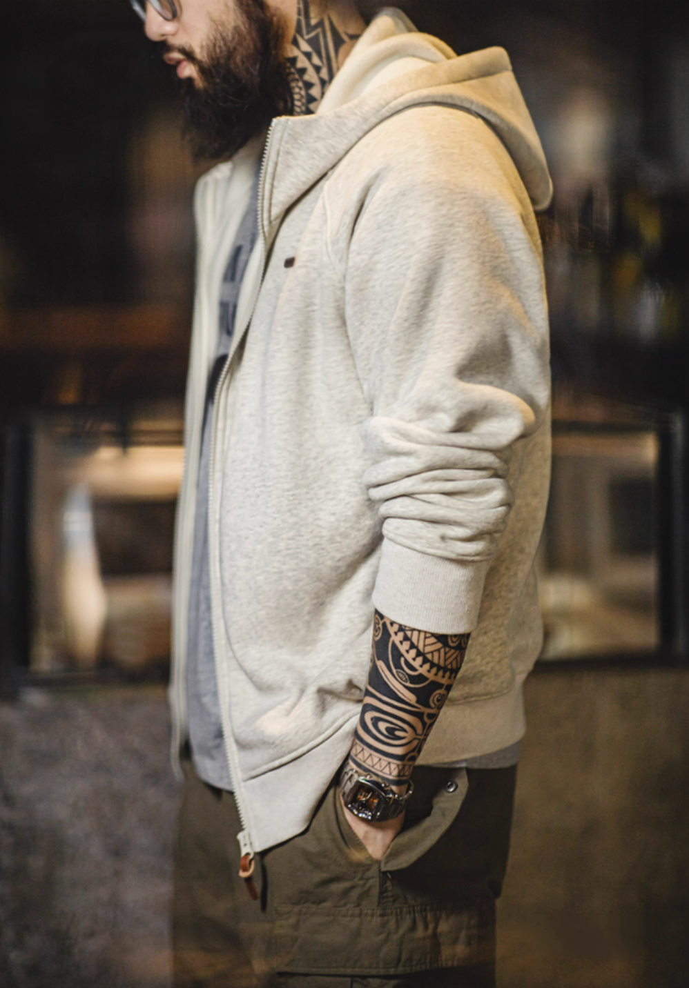 Side profile of snowflake white zip hoodie showing relaxed fit sleeve structure and clean silhouette