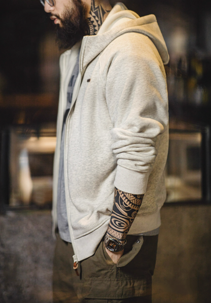 Side profile of snowflake white zip hoodie showing relaxed fit sleeve structure and clean silhouette