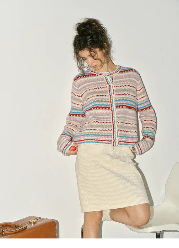 Beige striped fair isle cardigan full body outfit paired with skirt showing relaxed winter styling