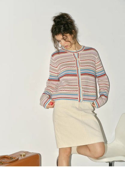 Beige striped fair isle cardigan full body outfit paired with skirt showing relaxed winter styling