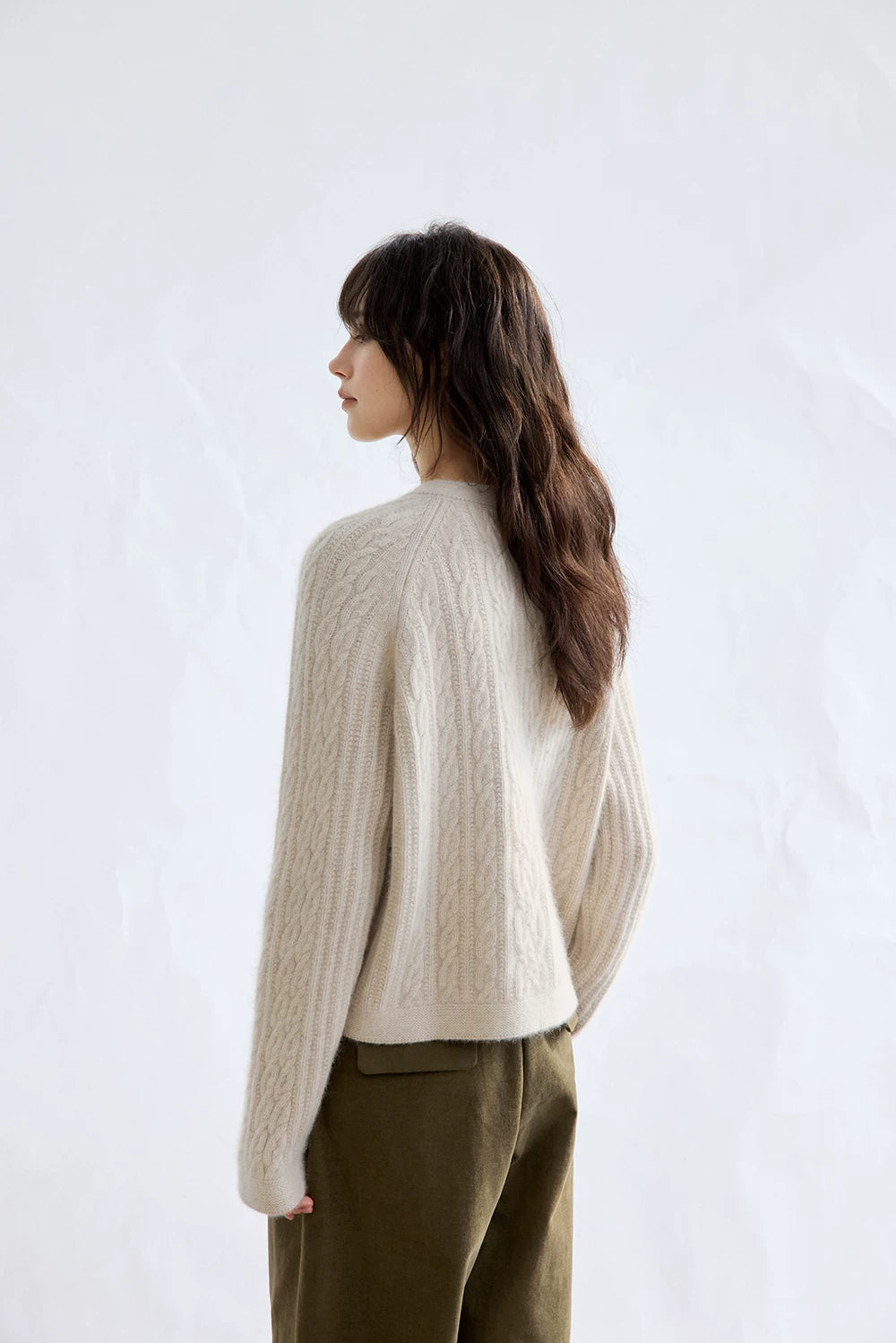 Oatmeal cable-knit wool cardigan, back view on model