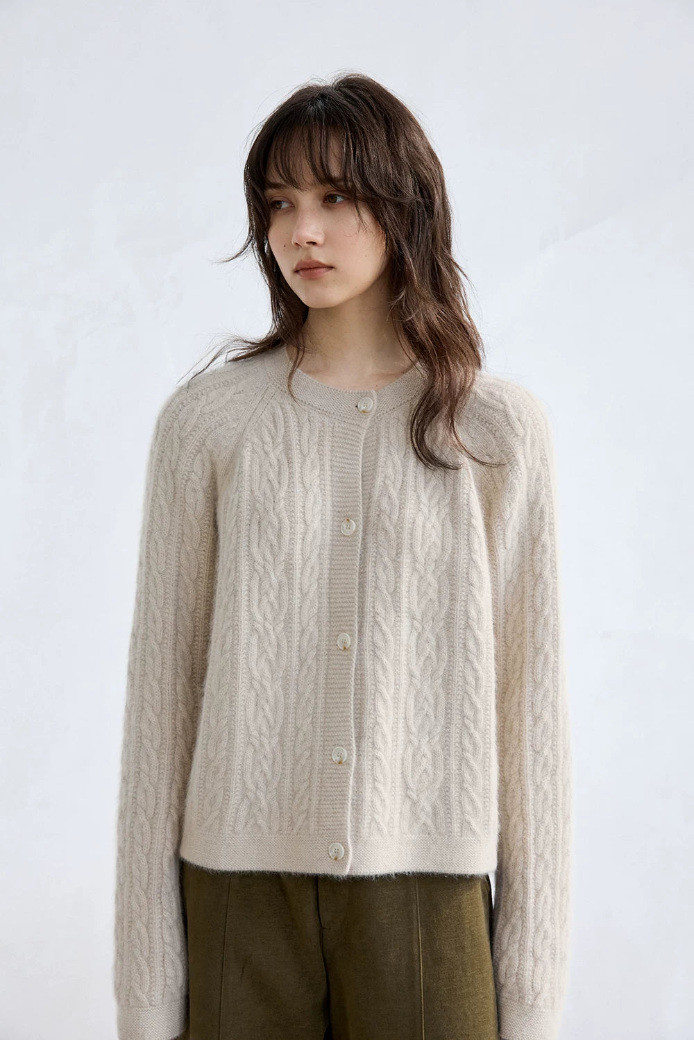 Oatmeal cable-knit cardigan, close front view with round neckline