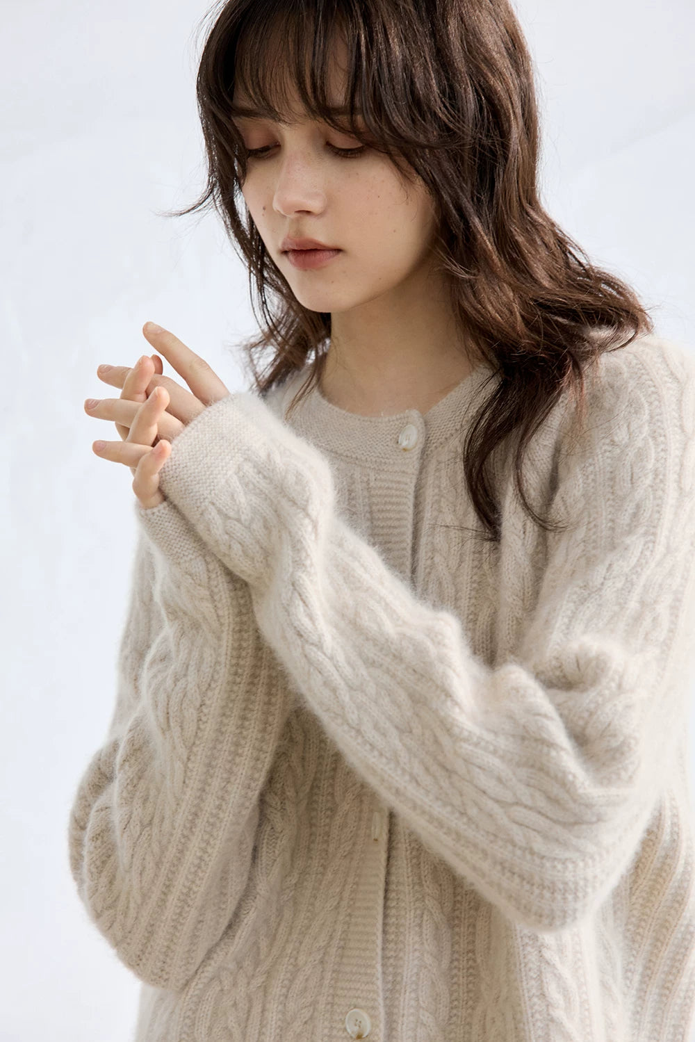 Oatmeal wool cardigan, close-up of round neckline and button