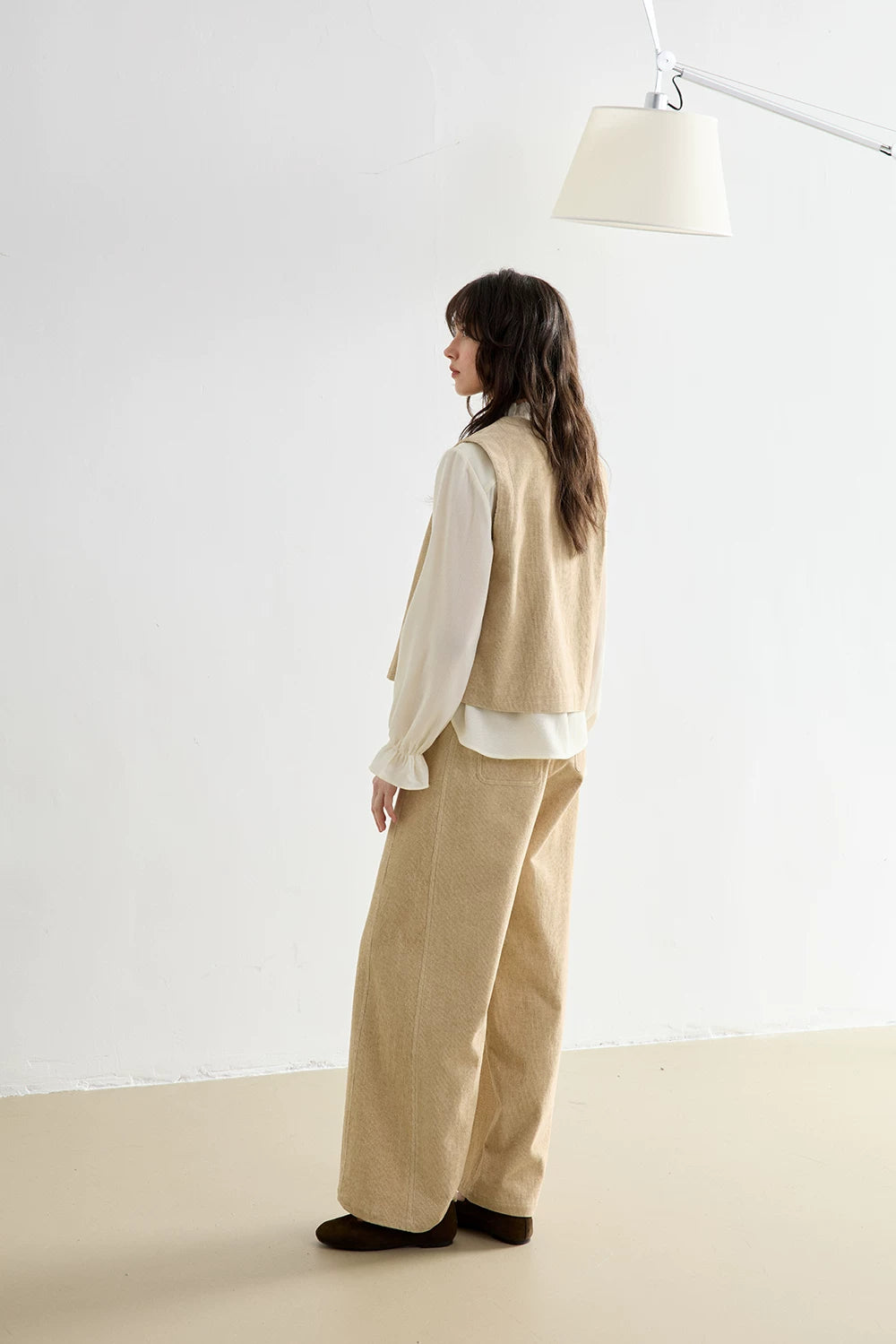 Back and side view of Oatmeal corduroy vest and wide-leg pants showing back pocket