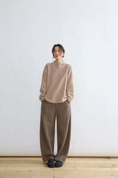 Full-length look of Oatmeal wool-blend hoodie styled with taupe wide-leg trousers and grey slippers