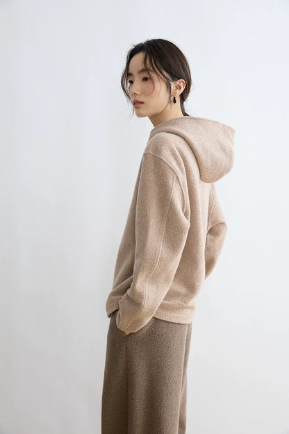 Side view of Oatmeal wool-blend hoodie showing the hood and relaxed sleeve