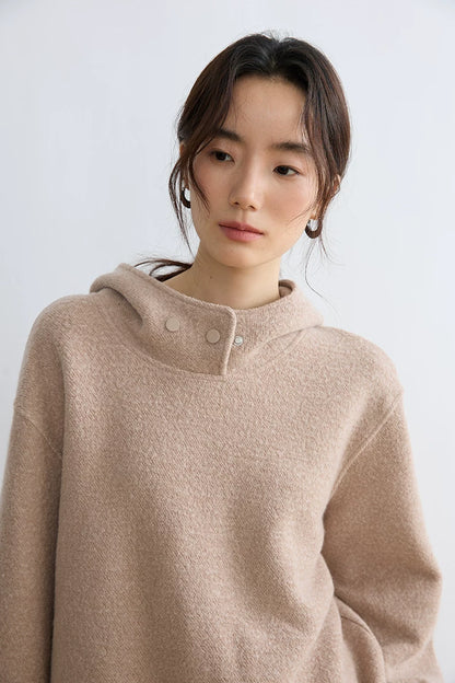 Close-up of Oatmeal textured wool hoodie showing overlapping neck panel with metal snap buttons