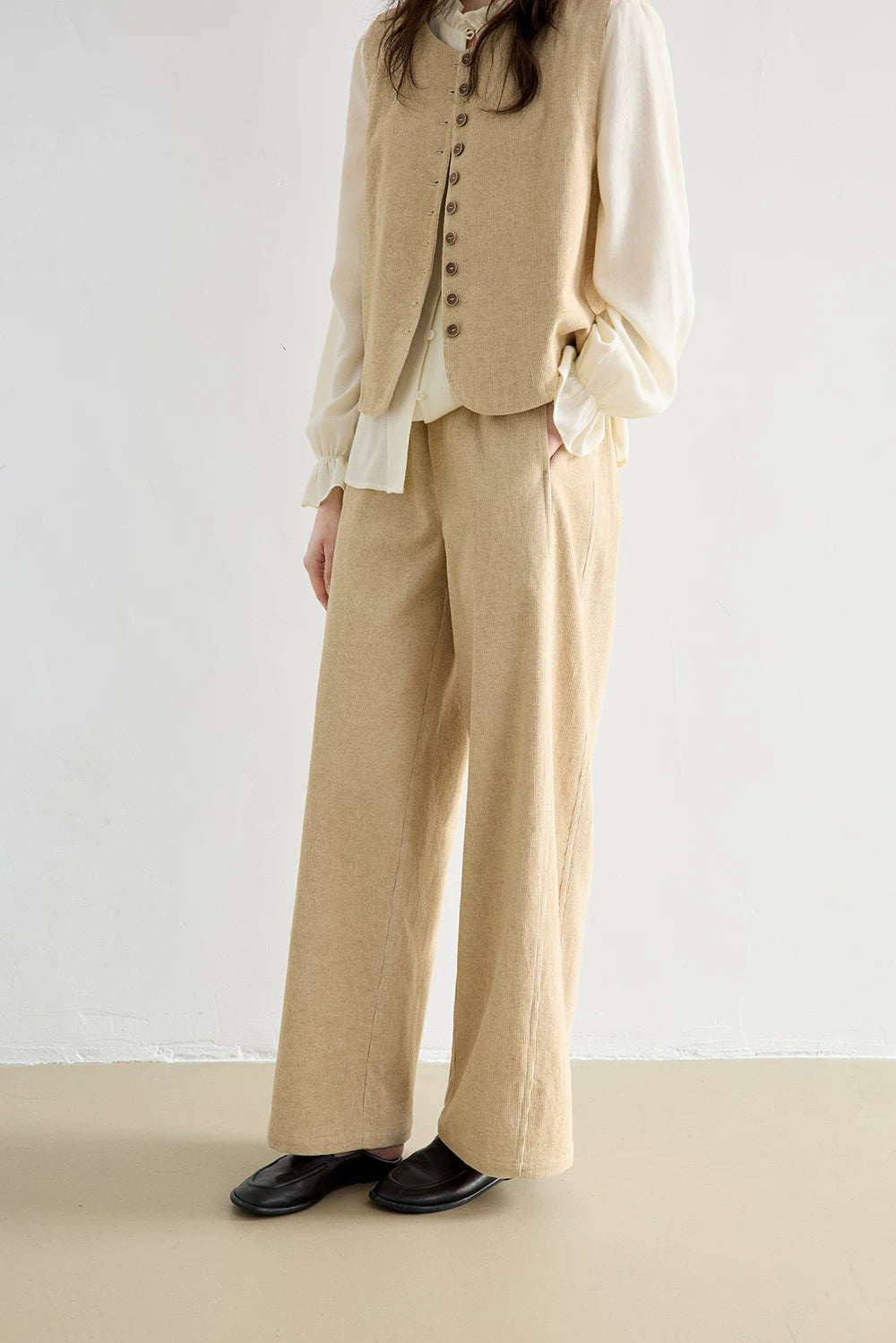 Oatmeal elastic-waist wide-leg corduroy pants showing straight, full-length drape