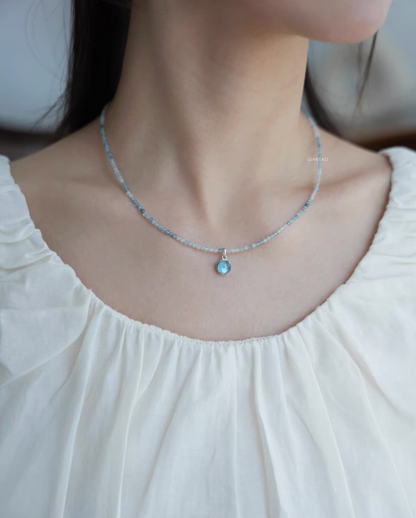 Ocean Breeze aquamarine necklace worn on neck showing light blue gemstone beads and aquamarine pendant
