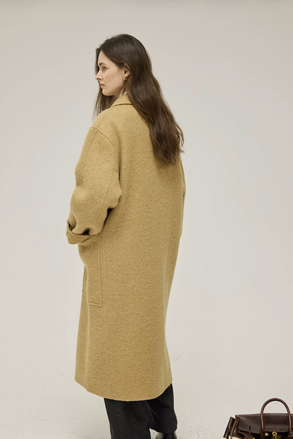 Back view of an Ochre straight-cut wool coat showing dropped shoulders and mid-calf length