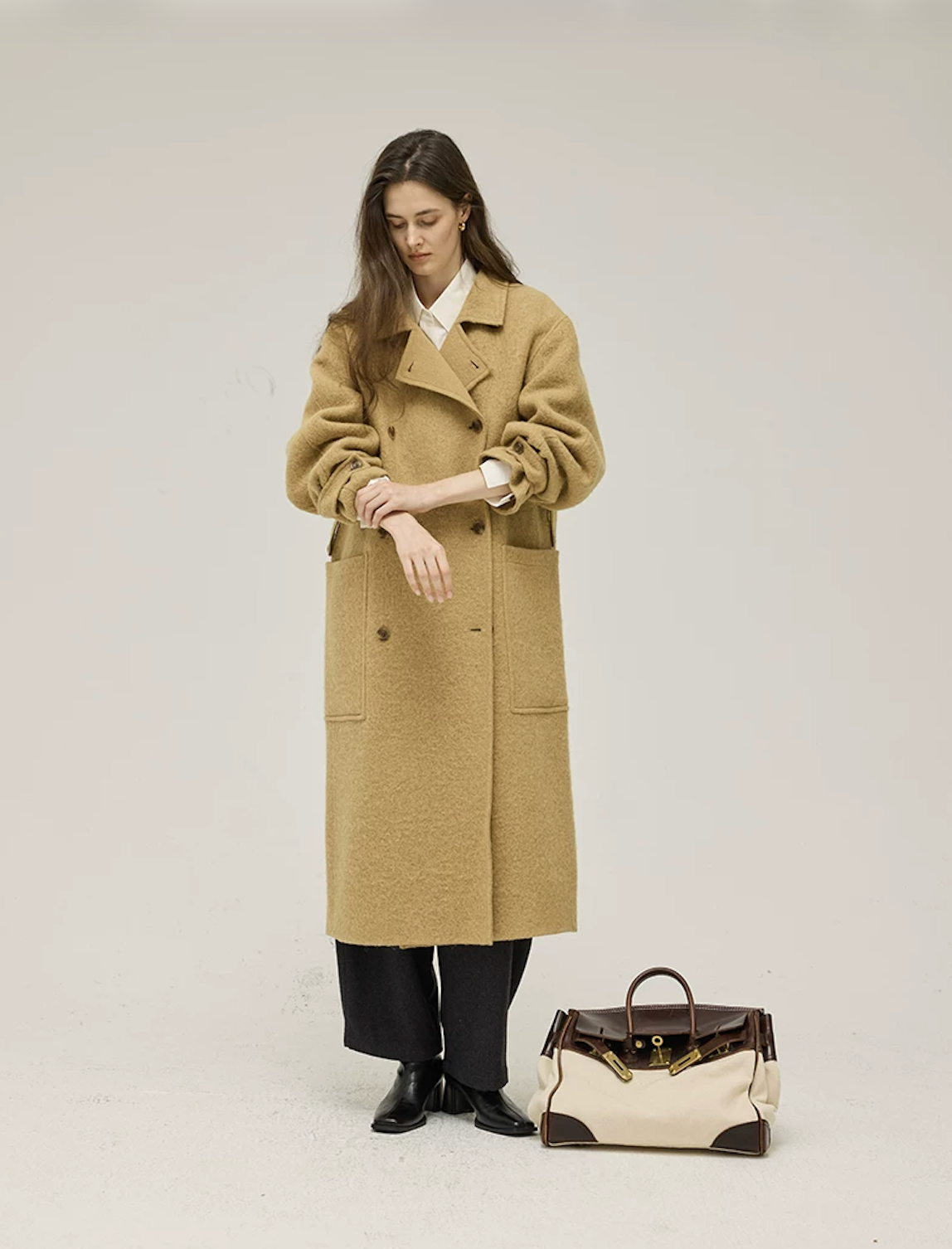 Ochre mid-calf wool coat with sleeves pushed up and two large patch pockets