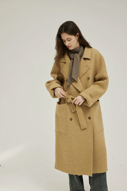 Ochre double-breasted wool coat with notched lapels, self-tie belt, and cuffed sleeves