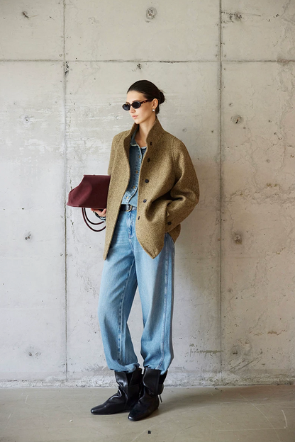 Full-length view of an Olive wool tweed jacket worn open with stand collar and hip-length hem