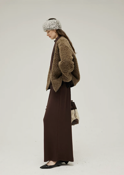 Side view of an Olive Brown curly wool teddy jacket with dropped shoulders and straight hem