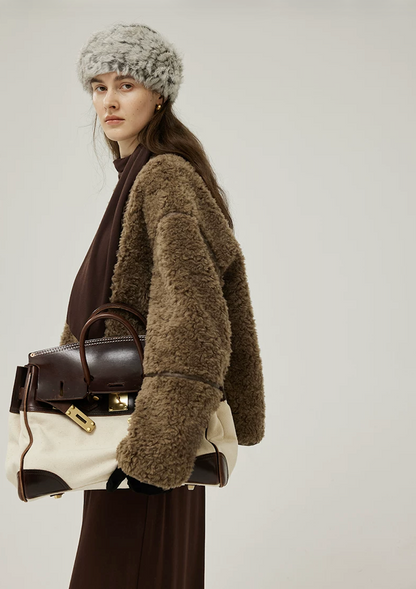 Olive Brown curly wool jacket showing the sheepskin trim along the sleeve seam
