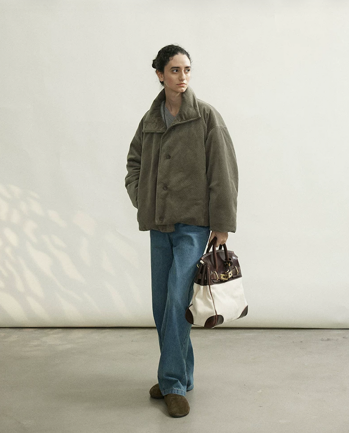 Full-length view of an Olive Gray cropped corduroy down jacket with button front
