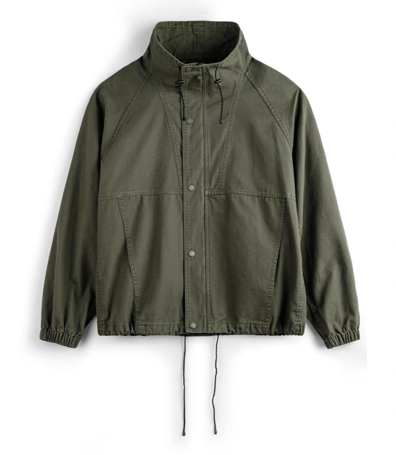 Men’s olive green M-65 utility jacket front view with stand collar and snap closure