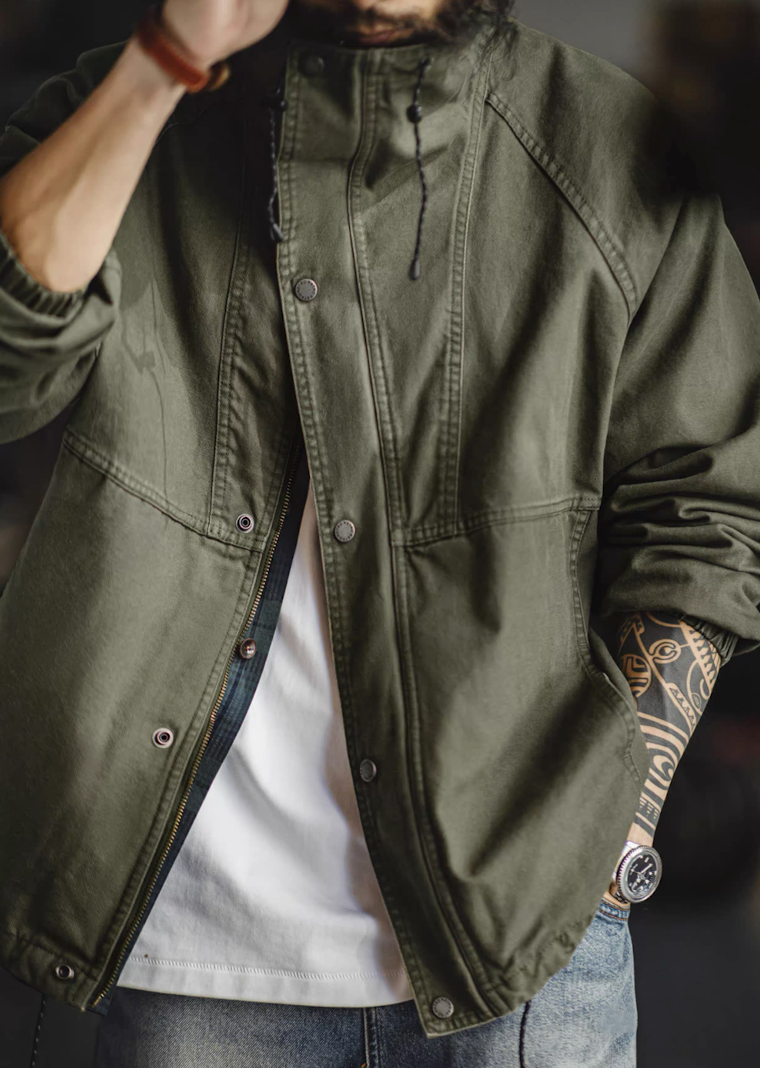 Olive green M-65 jacket styled open with zipper and snap button closure visible