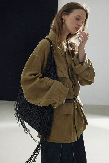 Olive linen shacket with rolled cuffs and dropped shoulders, side view