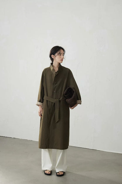 Full-length front view of an Olive belted trench coat falling to mid-calf