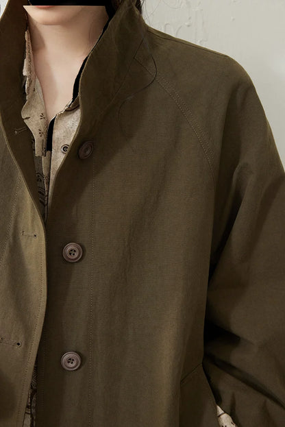 Close-up of an Olive cotton trench coat&