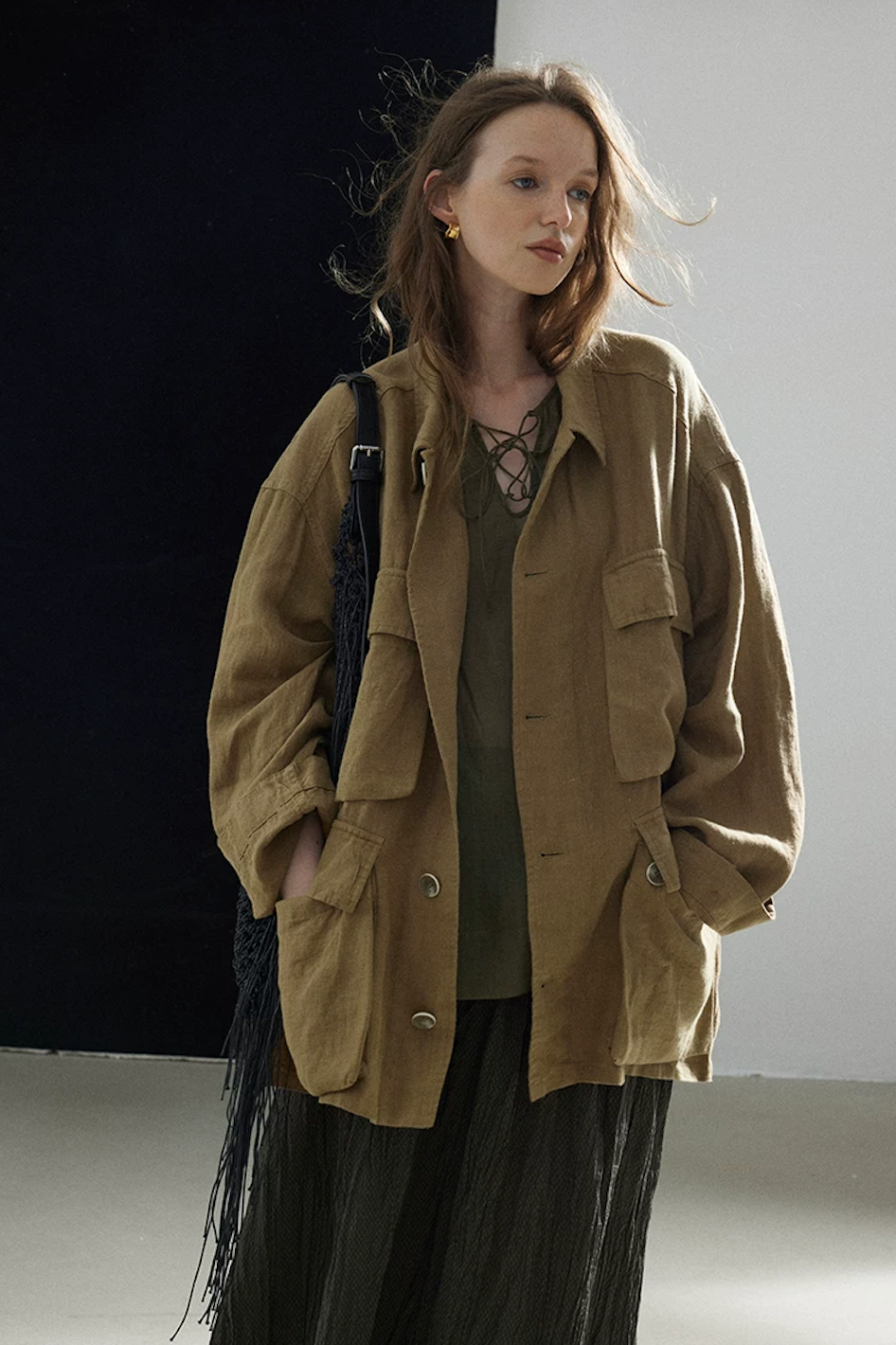 Olive sand-washed linen shacket worn open with four flap pockets, front view