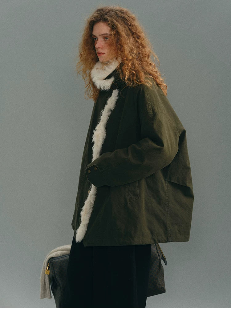 Side profile of an Olive goose down parka showing the boxy cut and shearling front trim