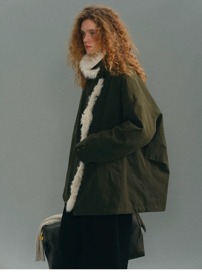 Side profile of an Olive goose down parka showing the boxy cut and shearling front trim