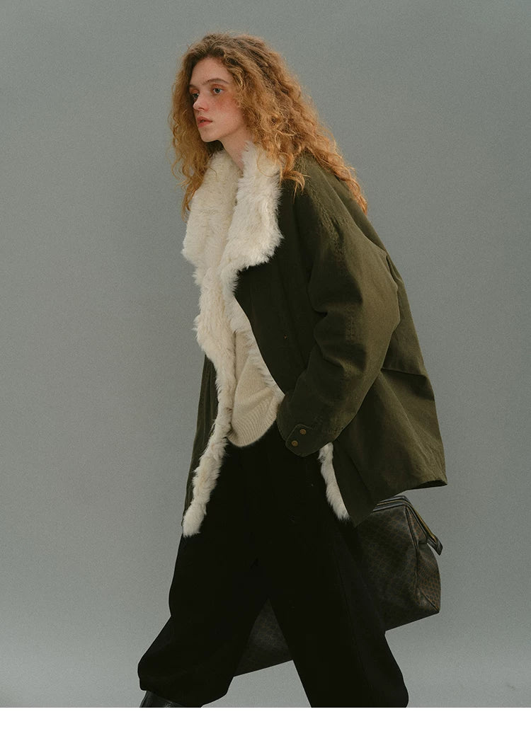 Olive shearling-trimmed down parka in motion, worn open with wide lapels