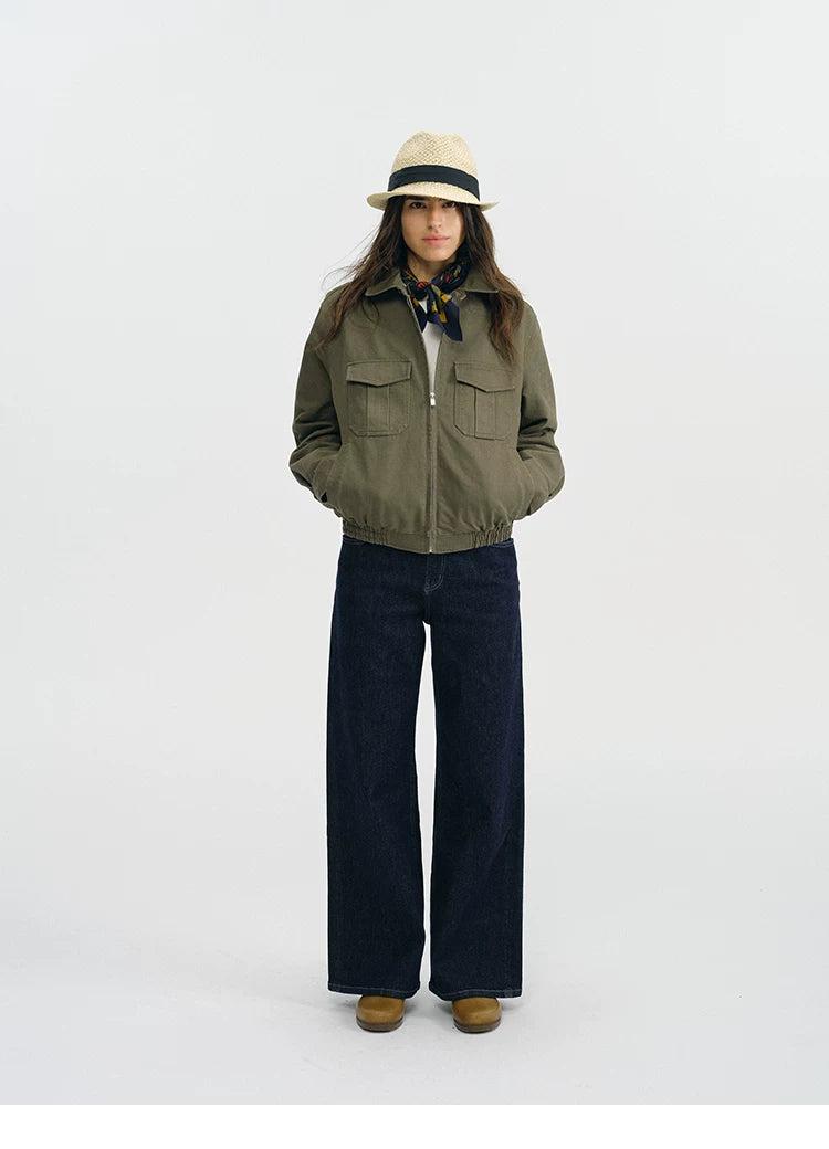 Full-length view of an olive utility jacket zipped up with collar turned down