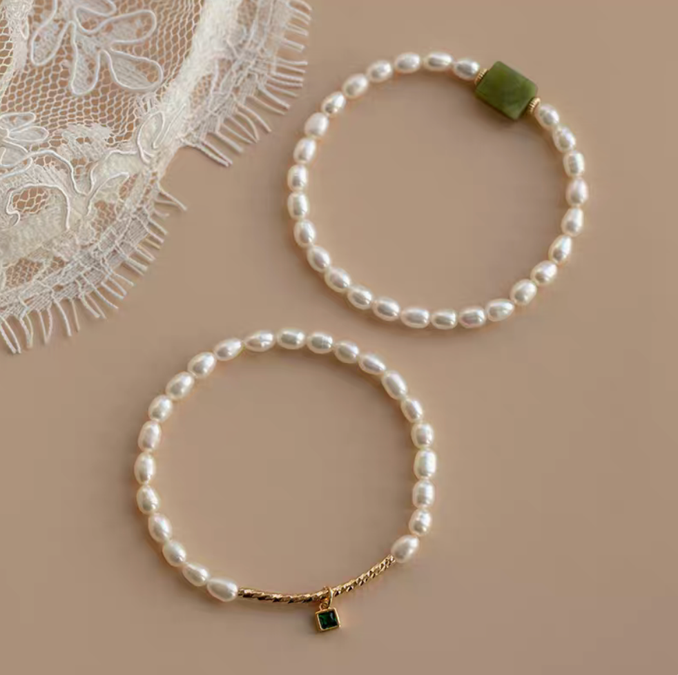 Flat lay showing both olivine design and square gemstone design pearl bracelets side by side in natural color.