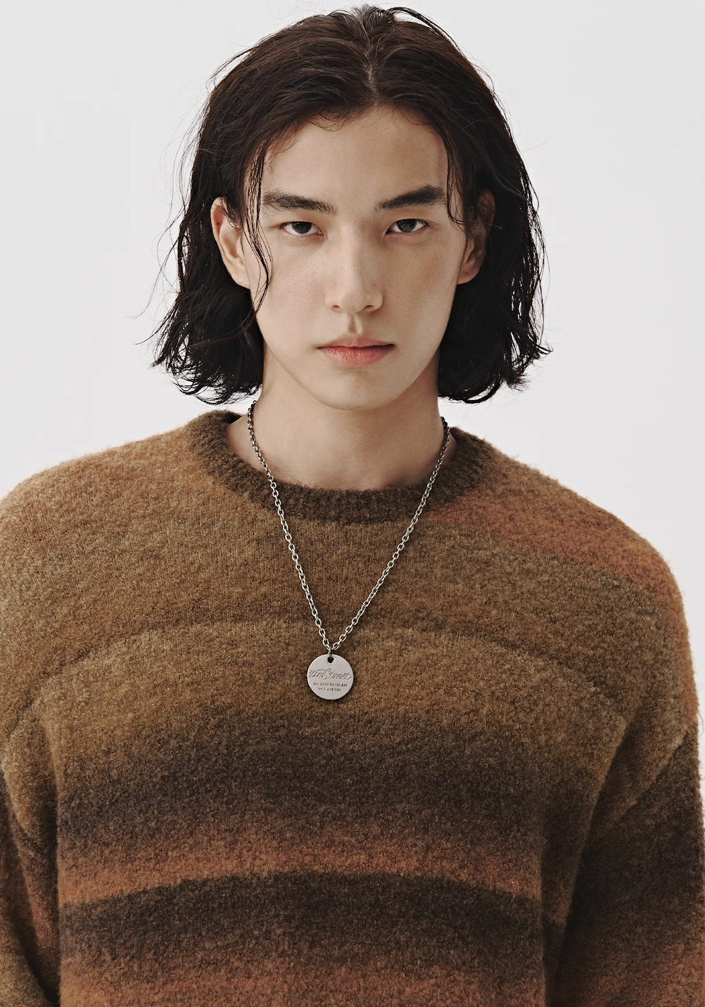 Warm sienna ombre knit sweater close-up, brushed wool-like texture.