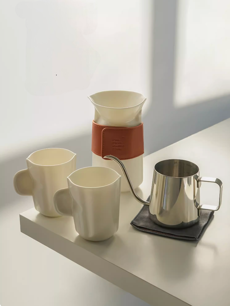 Milk White pour over coffee set with ceramic cups, filter cup, and stainless steel kettle arranged on table