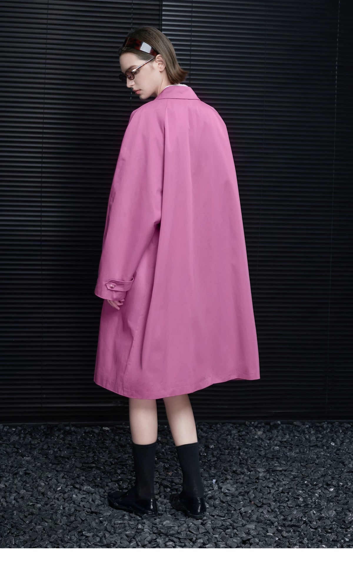 Back view of an Orchid Pink swing coat showing the flared A-line shape and buttoned cuff tab