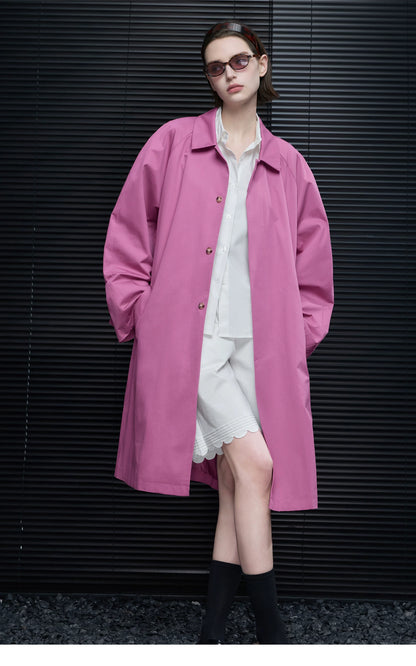 Orchid Pink oversized cotton coat worn open with point collar and hands in the side pockets