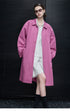 Orchid Pink oversized cotton coat worn open with point collar and hands in the side pockets